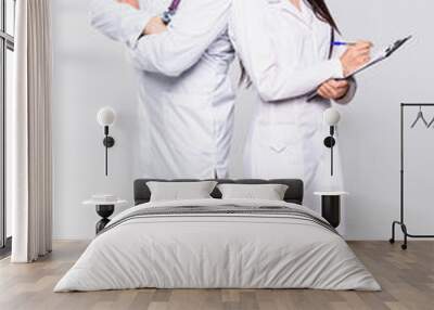 Portrait of two smiling medical workers isolated on white background Wall mural